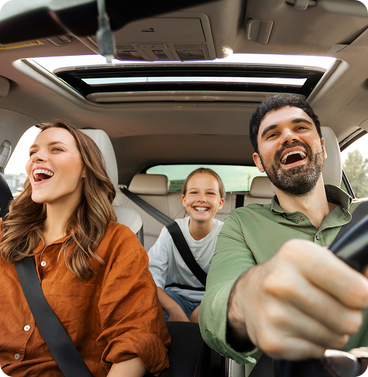 A joyful family enjoying a car ride together.